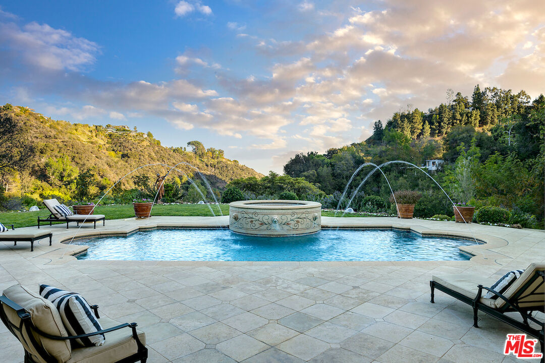 Pool and hillside view at 11025 Anzio Road in Los Angeles